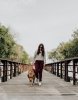 photo-of-woman-walking-on-dock-with-her-dog-2219928.jpg